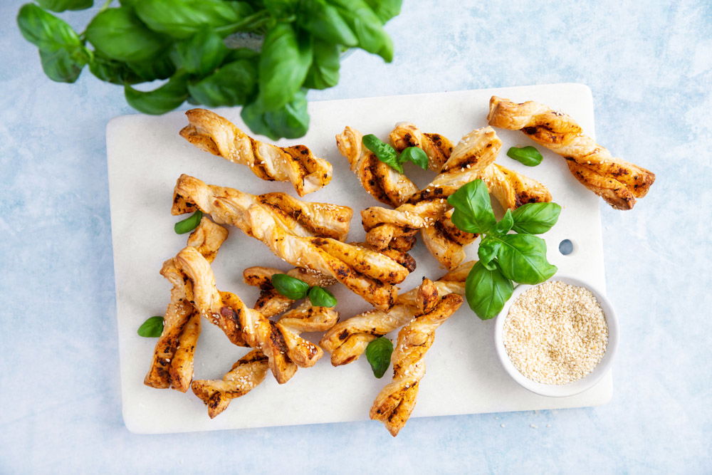 Kleine pesto bladerdeegstengels met sesamzaad